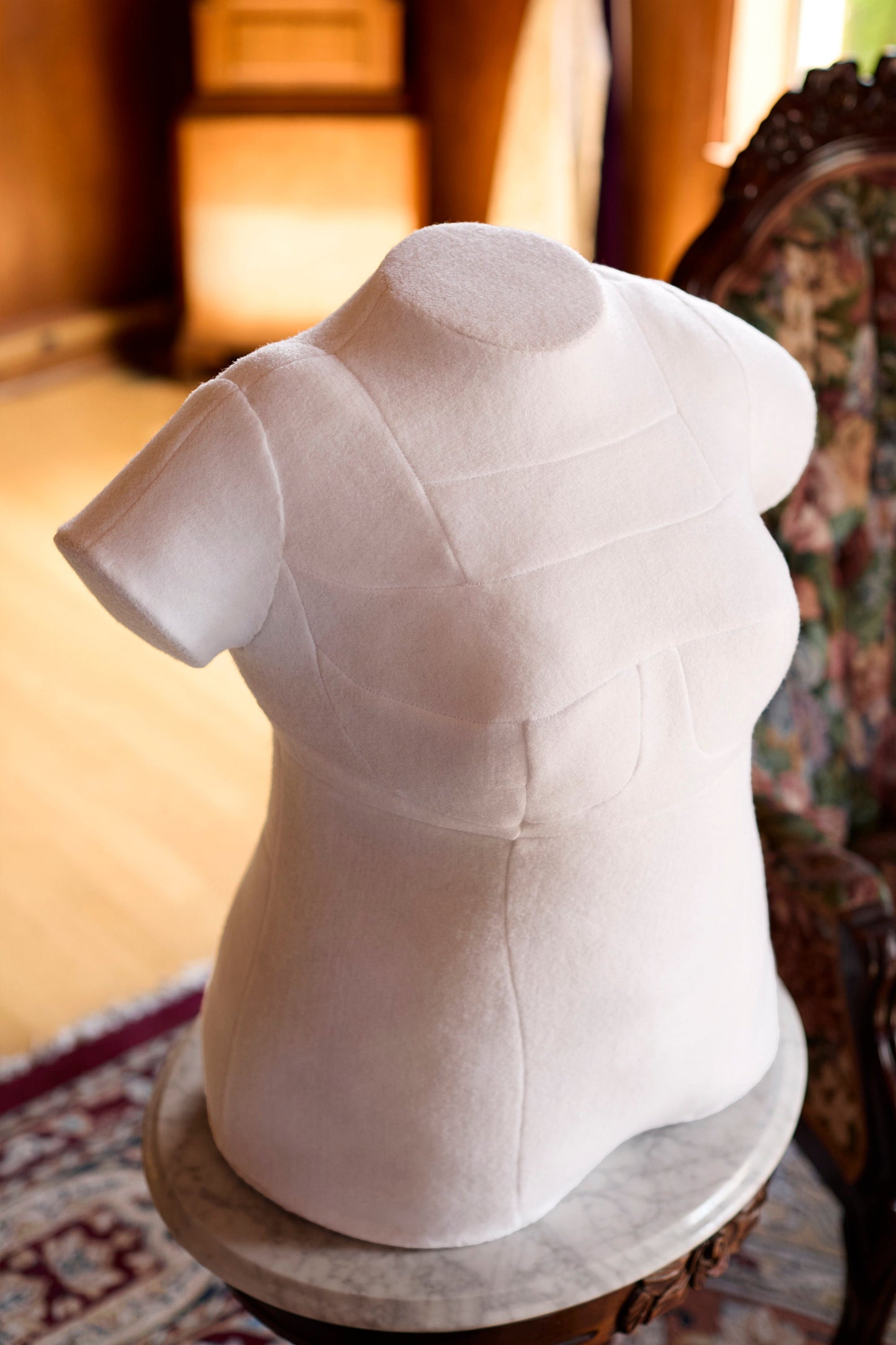 Upper angle view of bespoke form's integrated arm custom dress form