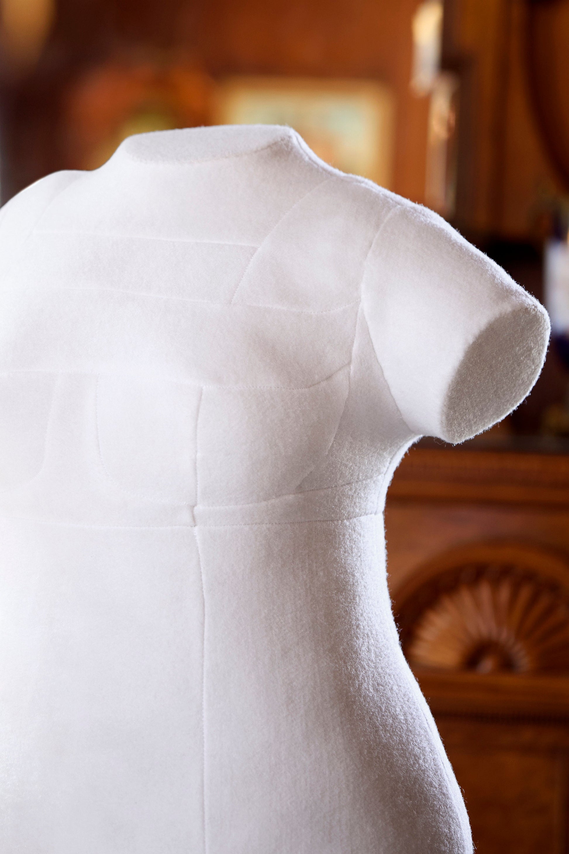 Close up view of bespoke form's integrated arm custom dress form